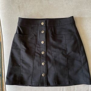 black skirt with silver buttons